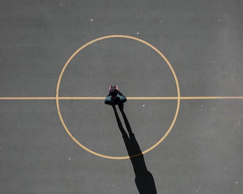 person standing on centre circle of netball court