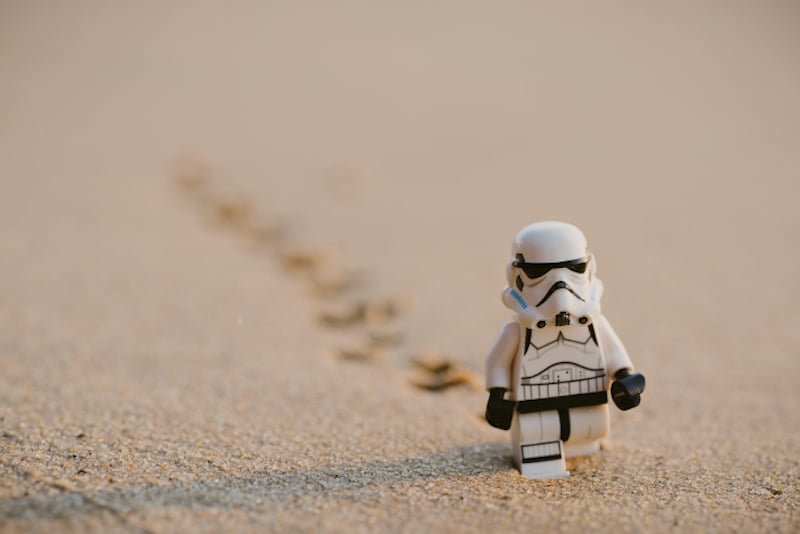 lego stormtrooper walking over sand